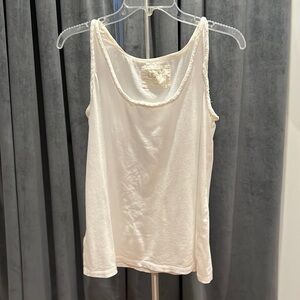 White tank top with detailing at arms and neck